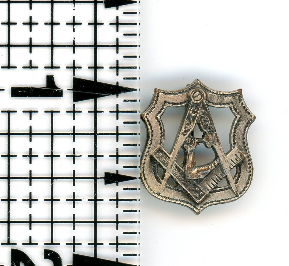 Lapel Pin from the Junior Order of United American Mechanics (Jr OUAM). Silver in color with safety pin attachment. Measures approximately 3/4 of an inch in height. 
